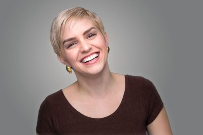 woman with a radiant smile thanks to a full mouth reconstruction in Rochester, MI