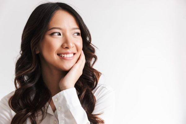 young adult woman smiling with teeth
