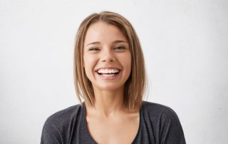 young adult smiling with teeth