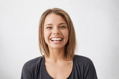 young adult smiling with teeth