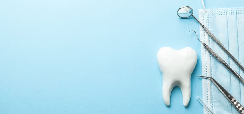 various dental tools on blue background