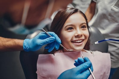 A little girl, excited for a dental visit
