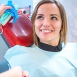 oral-surgery-image Young woman smiling up at a dentist