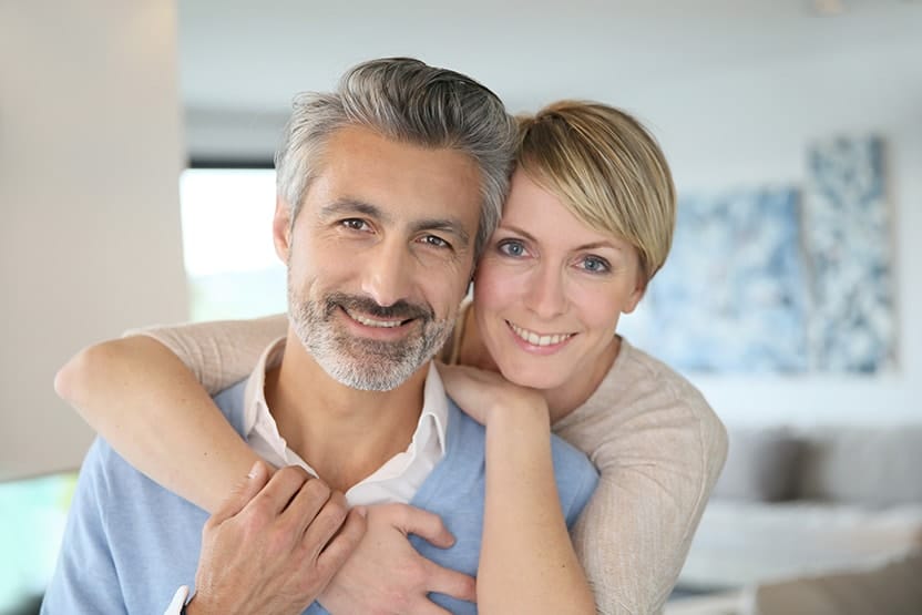 Mature couple embracing in a living room