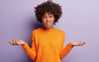 adult woman raising her hands up in question