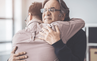 Two men hugging