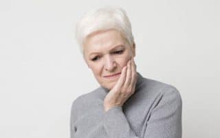 older woman with a toothache