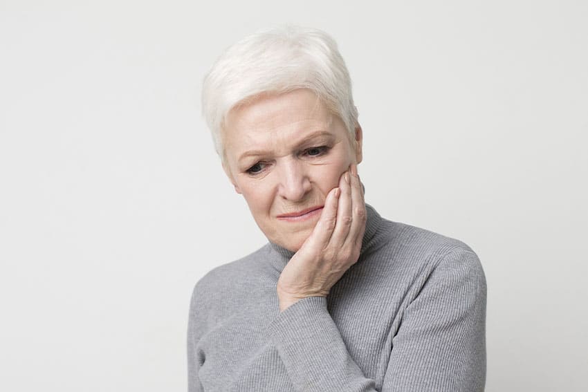 older woman with a toothache