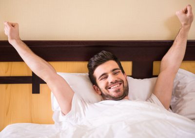 man waking up from a restful sleep thanks to a CPAP Alternative of sleep apnea treatment