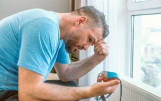frustrated man staring at cpap mask in his hand