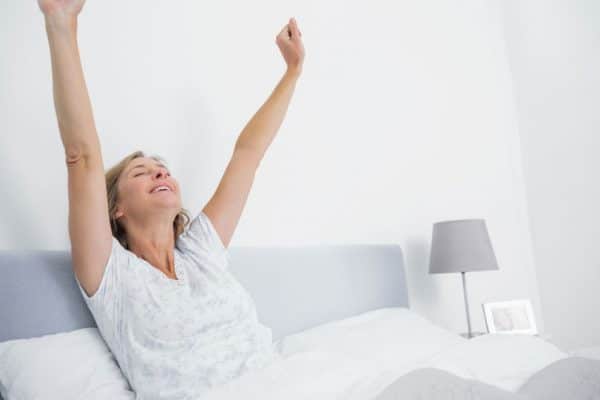 woman waking up happy and rested