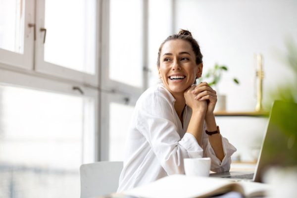 woman smiling and working at desk
