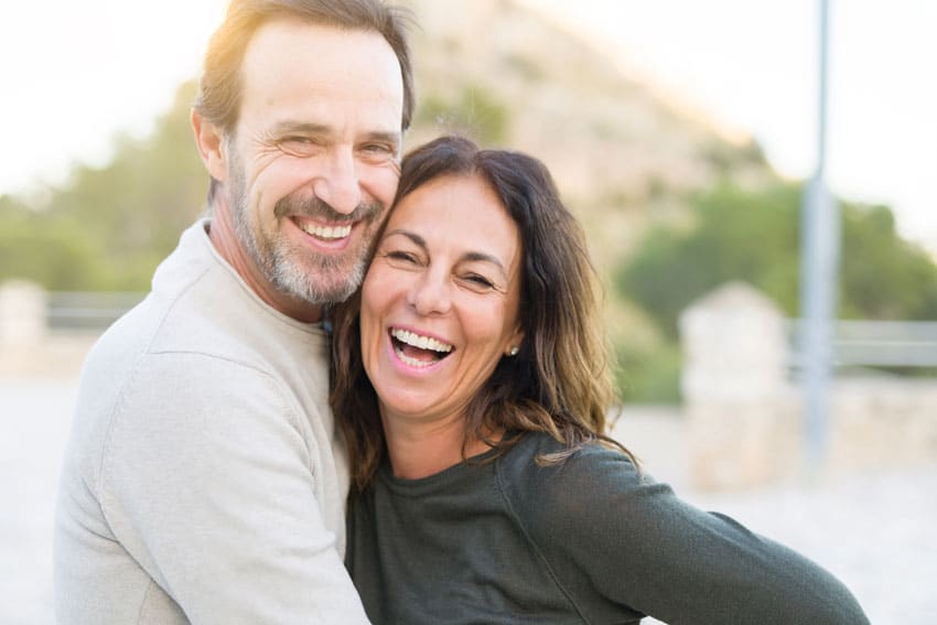 mature adult couple hugging and smiling