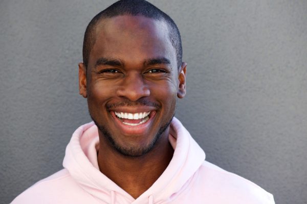 young adult man smiling with teeth