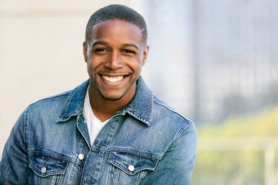 young adult man smiling with teeth